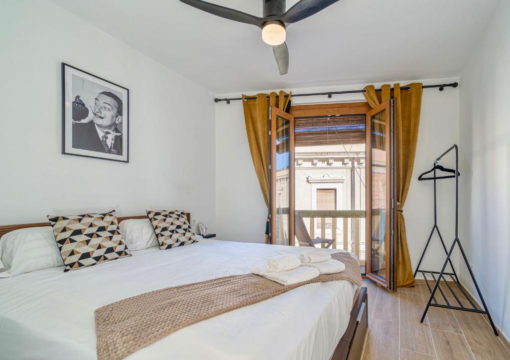 a bedroom with a large bed with a window at The Art Flat in Figueres