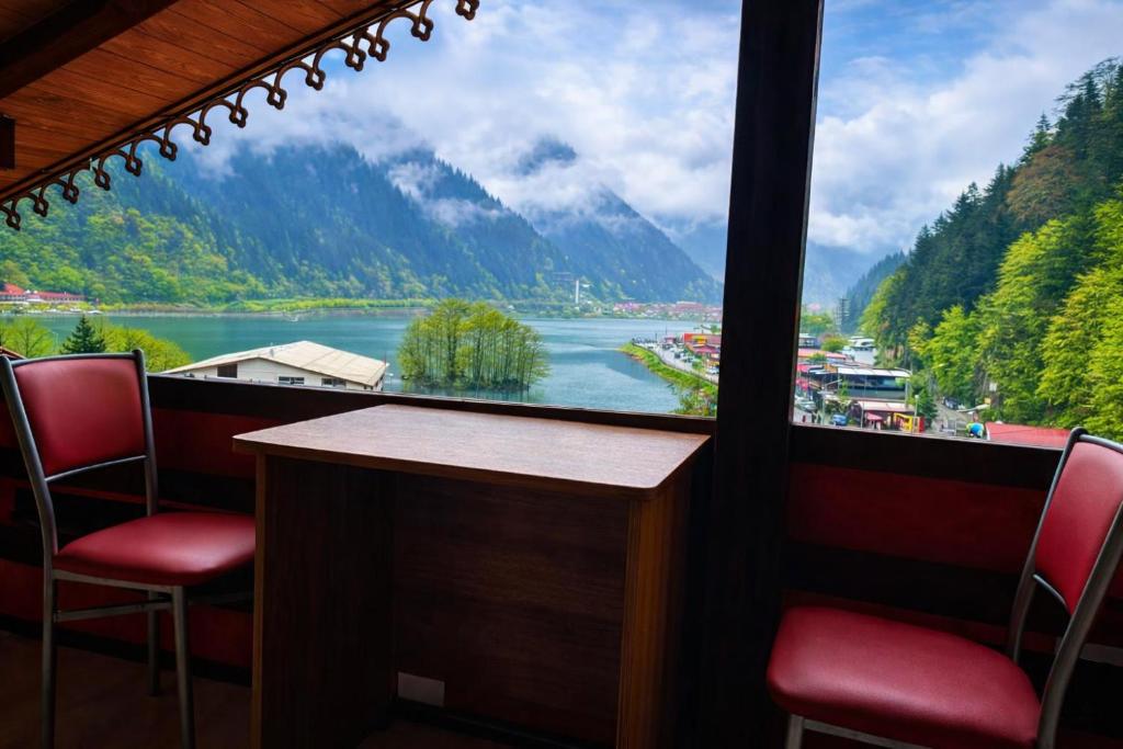 a room with a view of a river and mountains at CERRAHPAŞA SUİTE HOTEL in Uzungöl