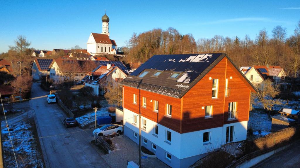 an overhead view of a house with a clock tower at LechApartments in Kaufering