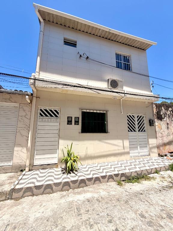 a white house with two garage doors on it at Torres Residence 2 in Recife