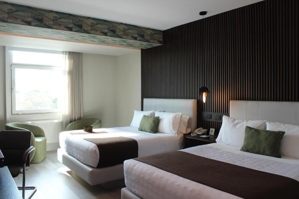 En eller flere senge i et værelse på Hotel Portobelo