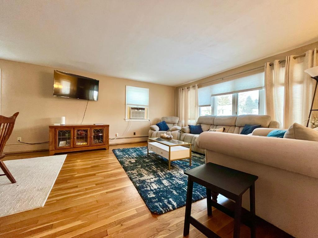 a living room with a couch and a table at Comfortable Room BU, UHS, Lourdes, Queen Bed in Endicott