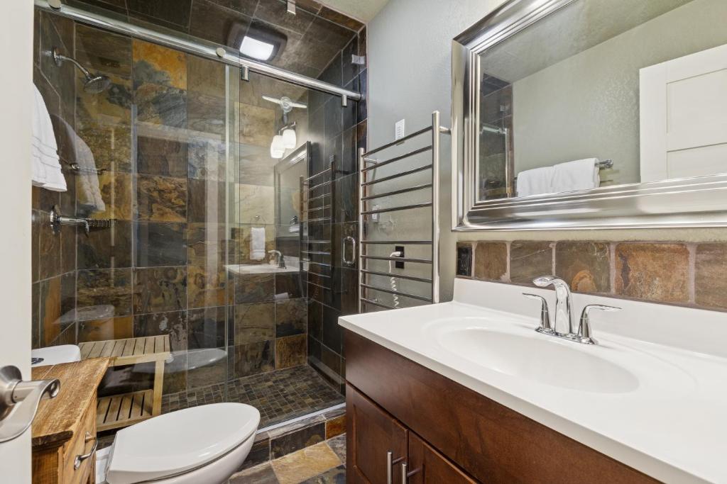 a bathroom with a sink and a toilet and a shower at Moose Tracks in Whitefish