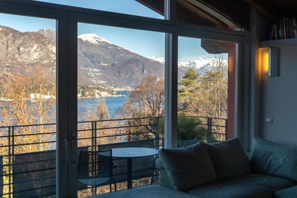 a living room with a view of a lake and mountains at Terrazzo apartment in Bellagio