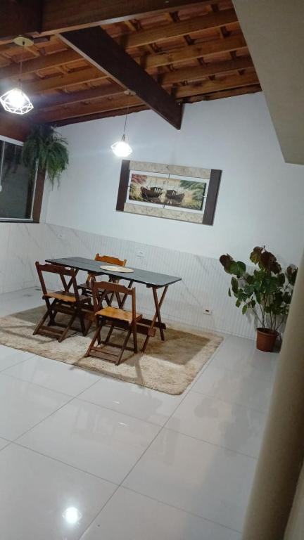 a dining room with a table and two chairs at Sobrado versátil in Santo André
