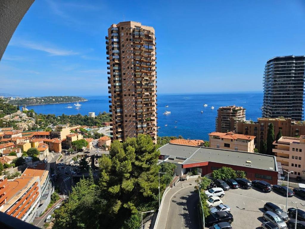 a view of a city with a tall building and the ocean at Casa Bellevue in Beausoleil