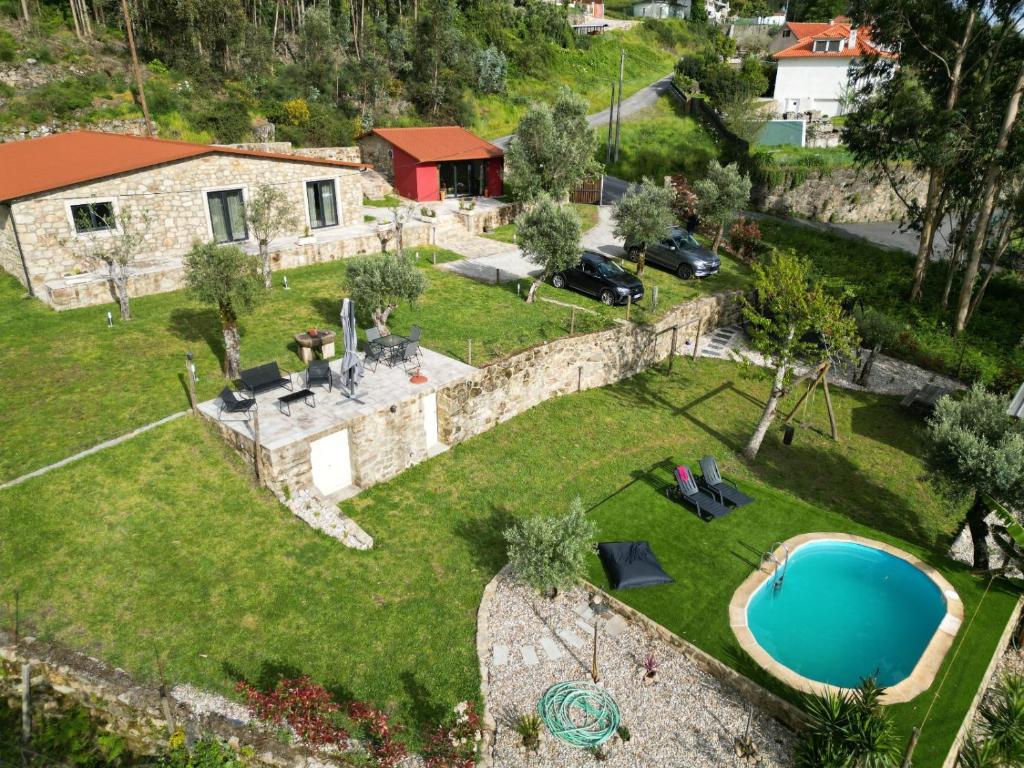 an aerial view of a house with a swimming pool at Casas de Correndelos in Ponte de Lima