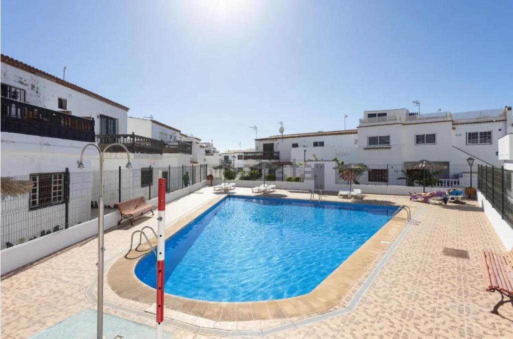 a swimming pool on the side of a building at 1 BR Condo Chapelas Costa del Silencio AC Pool WIFI in Arona