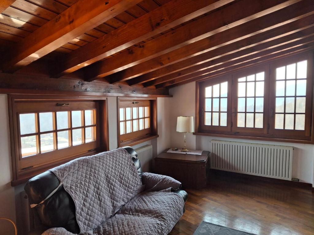 a living room with a couch and some windows at La ca' dal Tunec in Valduggia