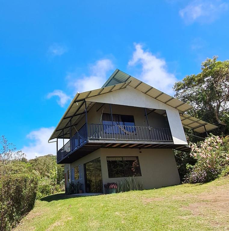 a house with a balcony on top of it at Monteverde Cecropia Paradise in Monteverde Costa Rica