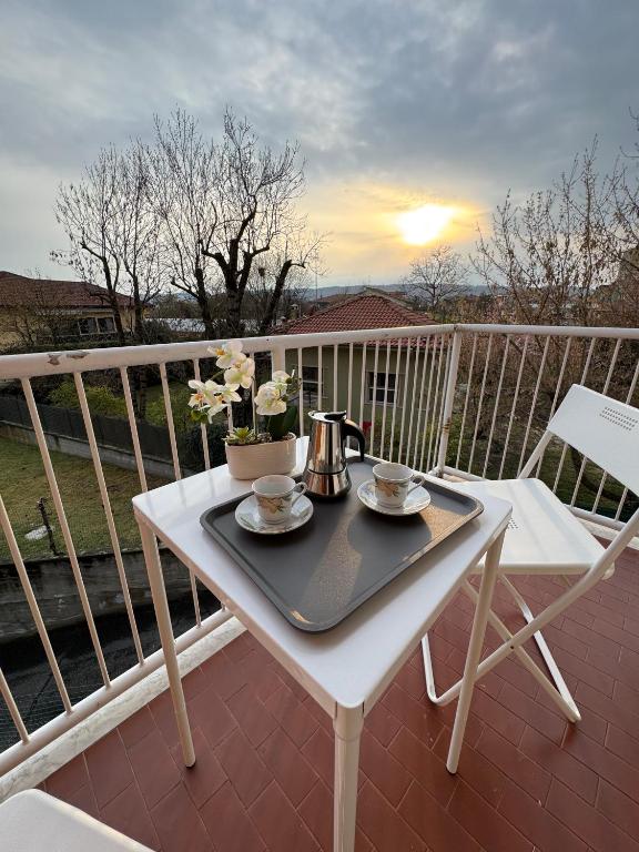 a table on a balcony with a tea set on it at Great Sweet Home in Strambino