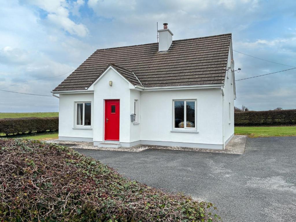 a small white house with a red door at 3 Bed in Ballyvaughan oc-ii09354 in Ballyvaughan