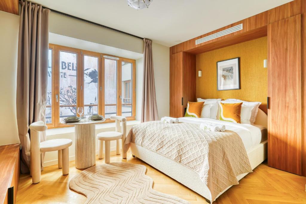 a bedroom with a large bed and a window at Paris La Belle - Lafayette in Paris