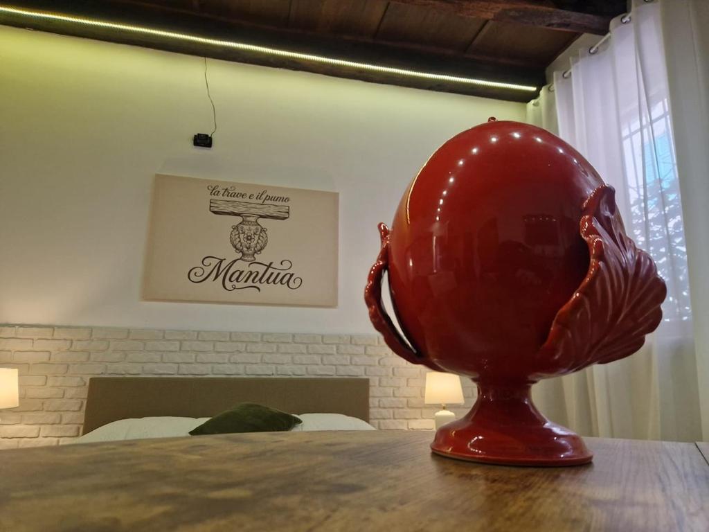 a large red egg sitting on top of a table at La Trave e Il Pumo Mantua in Mantova