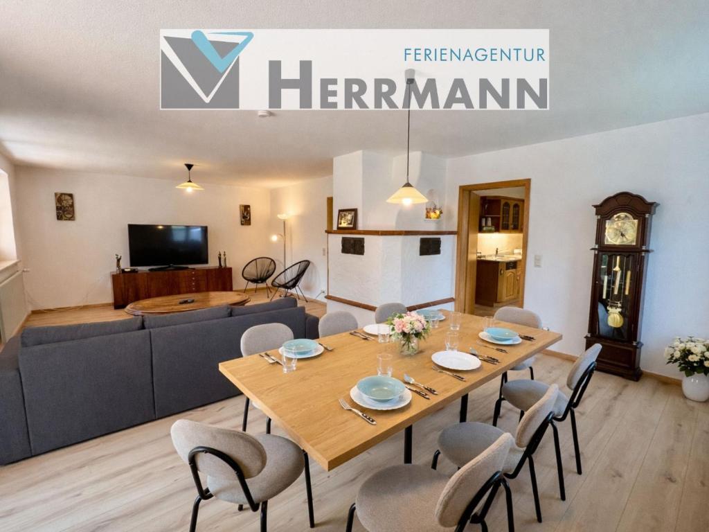 a dining room and living room with a table and chairs at Ferienhaus Kenzenkopf in Halblech