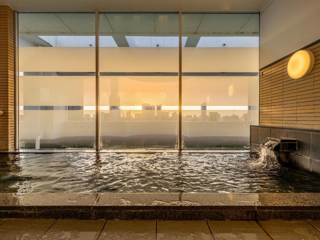 a pool of water in a building with a window at Hotel Meijiya in Hamamatsu
