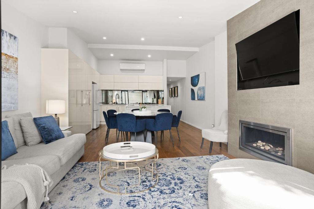 a living room with a couch and a fireplace at Albertine House in Melbourne