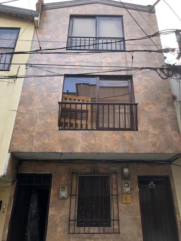 a building with a balcony with bars on it at Edificio AREAS by QuBeLab in Bello