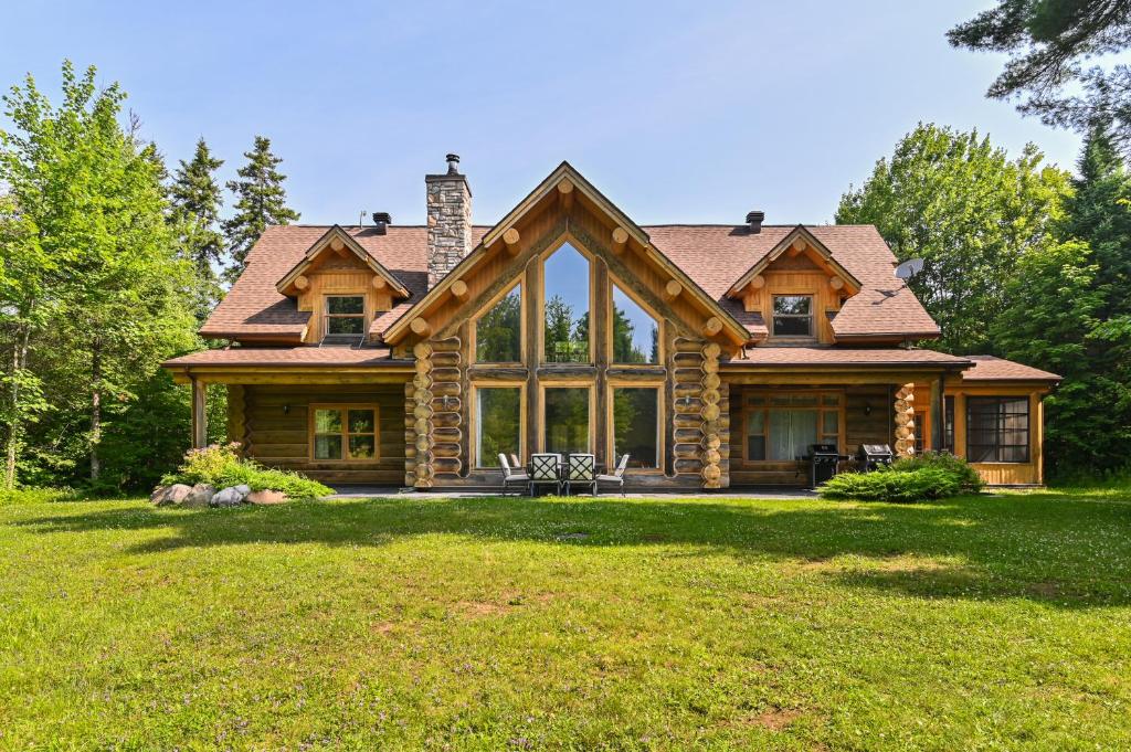 a log home with a large window at Fiddler Lake Resort - Moose 46 in Mille-Isles