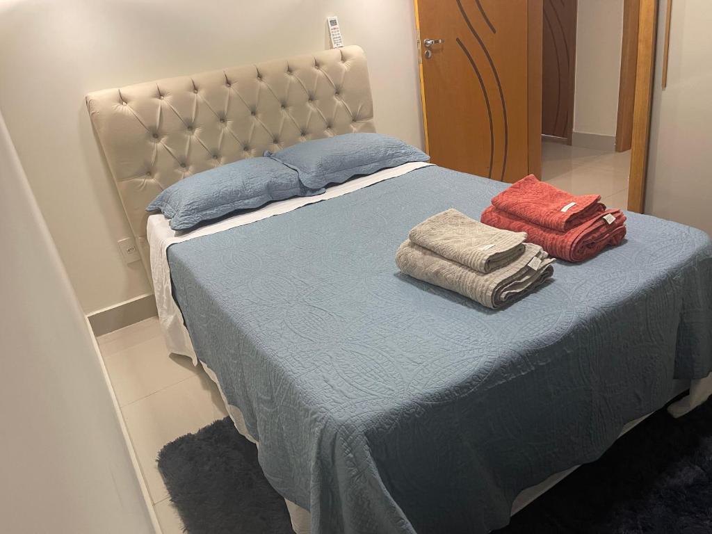 a bed with two pillows on it in a room at Royal Lion Bedroom in Londrina