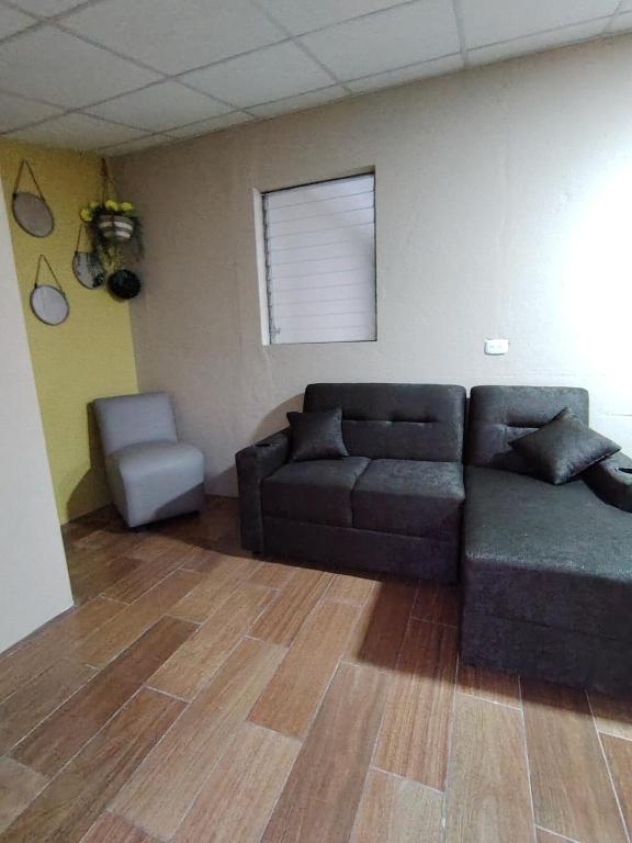 a living room with a couch and a chair at Beto's house in Santa Ana