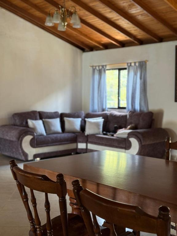 a living room with a table and a couch at Finca María Bonita in Horizonte