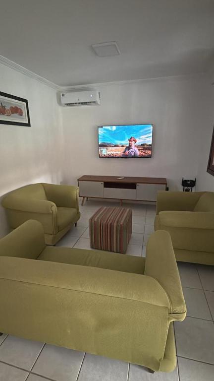 a living room with two couches and a flat screen tv at Privê Refúgio Gravatá in Gravatá