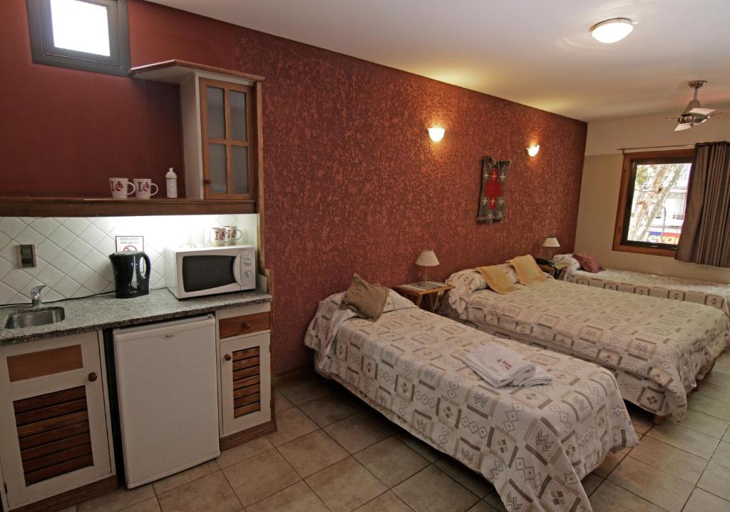 Postel nebo postele na pokoji v ubytování Hotel Xumec Mendoza