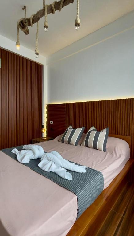 a bedroom with a large bed with towels on it at Speranza Hotel & Restaurant in Infanta