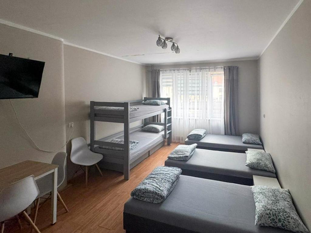 a room with four beds and a bunk bed at Żeromskiego 2024 in Gdynia