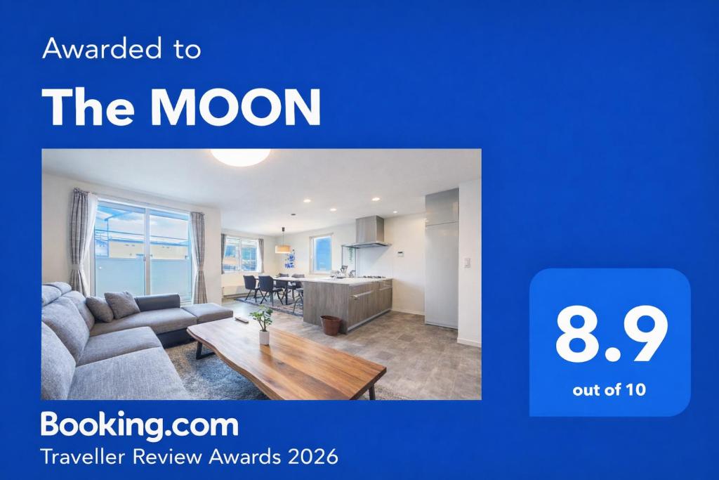 a living room with a couch and a table at The MOON in Sapporo