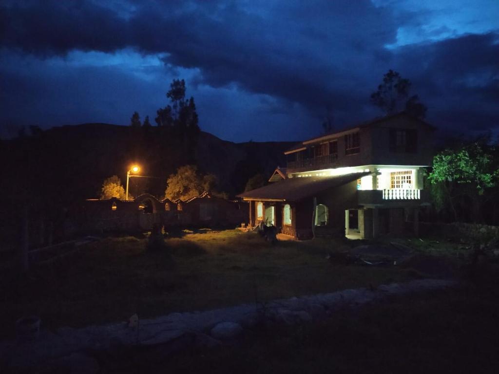 a house lit up at night with a street light at Sumaq Illary Bonito Amanecer in Urubamba