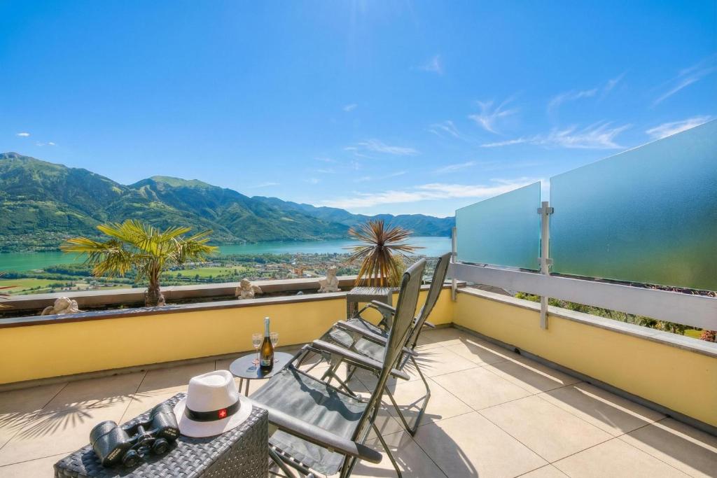 a balcony with a view of a river and mountains at Panorama Maggiore Apartment with Pool in Locarno - Happy Rentals in Locarno