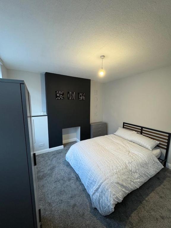 a bedroom with a bed and a sign on the wall at Stylish double room in Mansfield