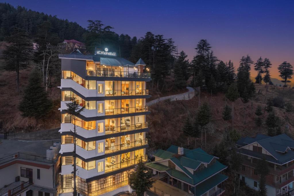 an aerial view of a building at night at Hotel Mountain Mirage in KumhÄrsain