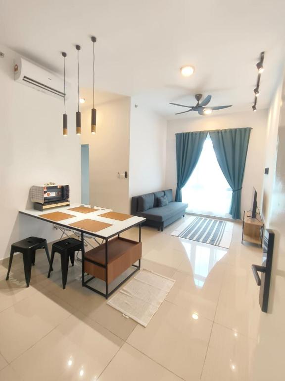 a living room with a table and a couch at Adilili Mesahill Premier Homestay, Nilai near KLIA USIM AEON Mall Mesa Mall Aurelius Hospital in Nilai