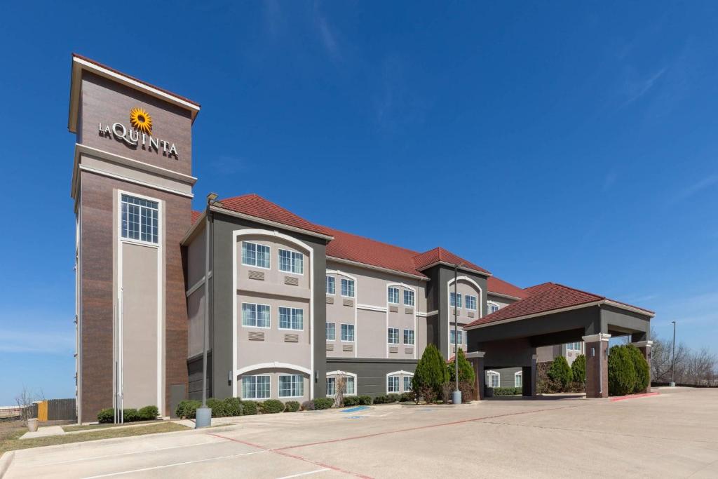 a hotel building with a sunflower on the front at La Quinta by Wyndham Kyle - Austin South in Kyle