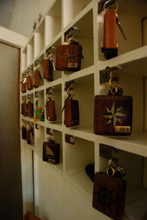 a wall filled with lots of lockiers on a shelf at Hotel Signorini in Castiglioncello