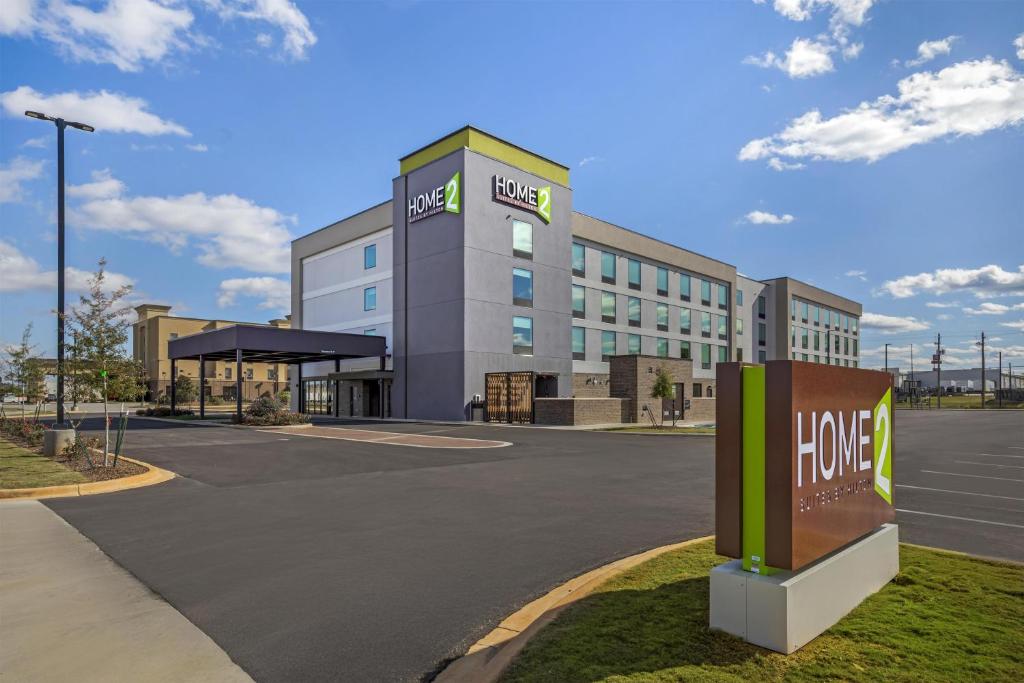 a large building with a home sign in front of it at Home2 Suites By Hilton Calera in Calera