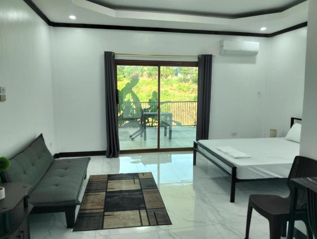 a living room with a couch and a table at Safe Haven Residence in Talibon
