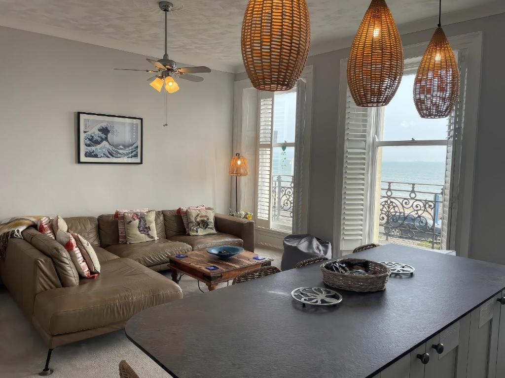 a living room with a couch and a table at Sunrise Apartment in Weymouth