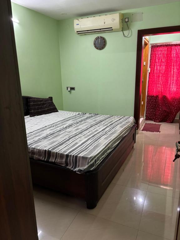a bed in a room with a red window at Satya Residency in Kākināda
