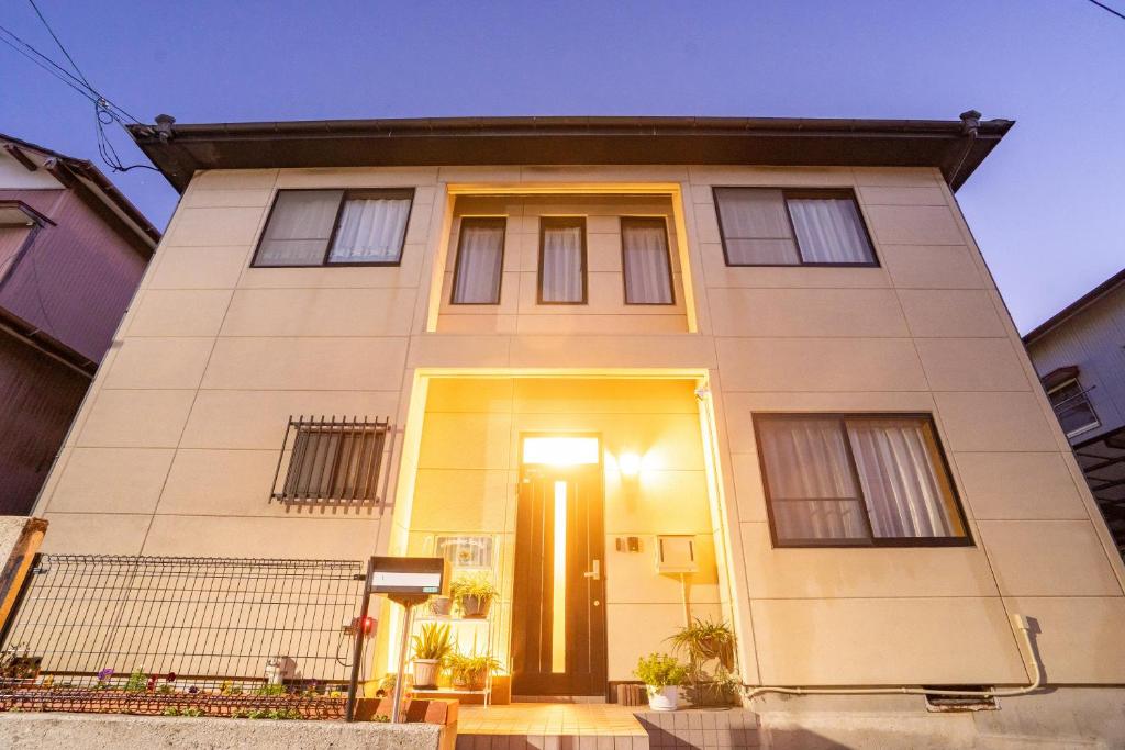 a white house with a front door at mintstay kochi in Kochi