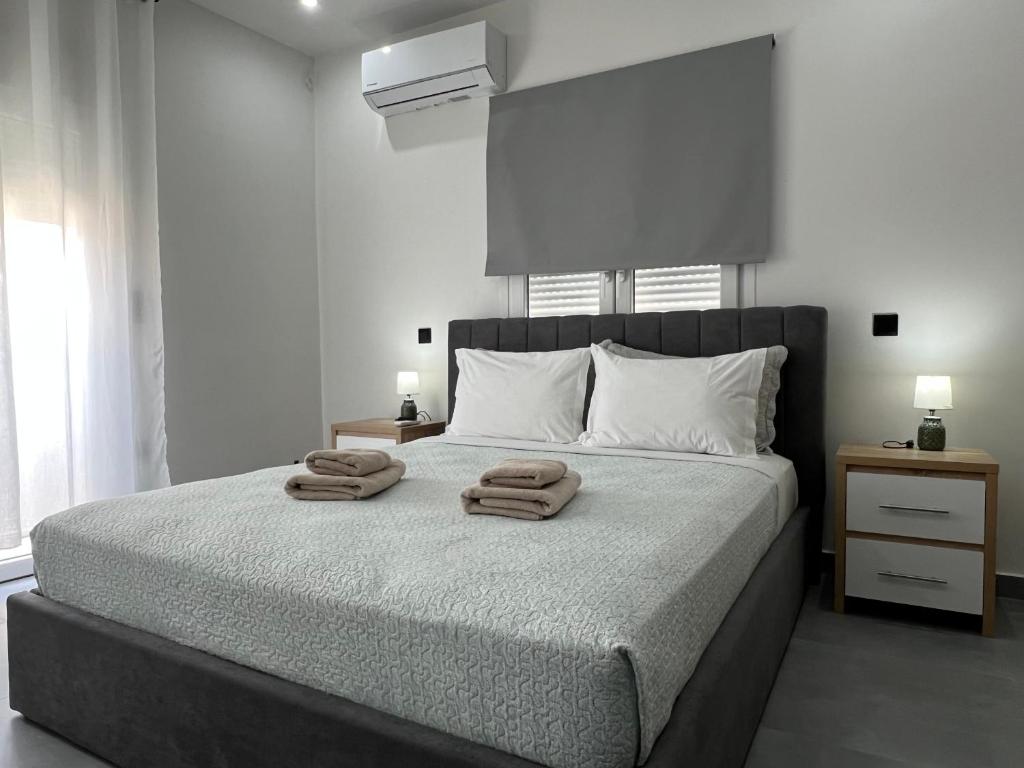 a bedroom with a bed with two towels on it at Kilada Luxury Apartment 2 in Koilás