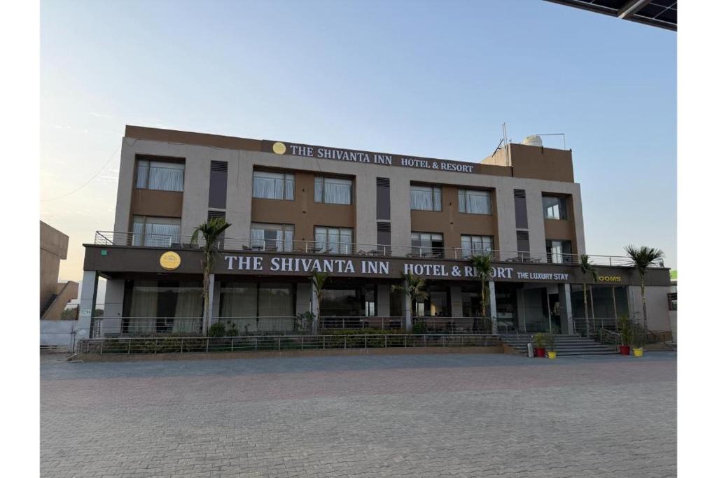 a building with a sign on the front of it at The Shivanta Inn in Ābu Road