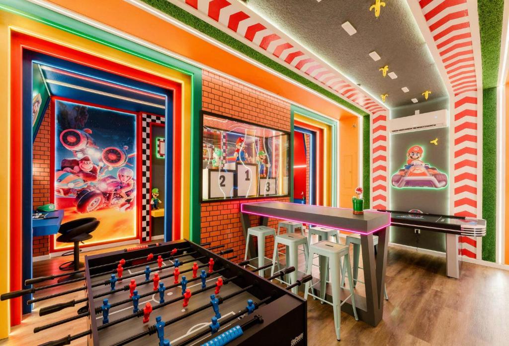 a room with a ping pong table in the middle at Spacious 9BR Home w Private PoolGame Room in Davenport