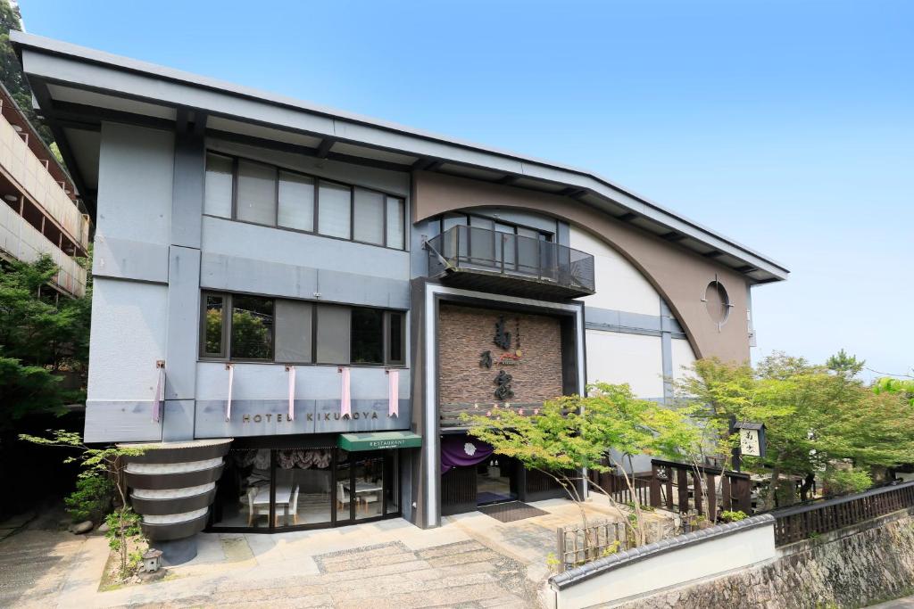 a building with a balcony on the side of it at Kikunoya in Miyajima