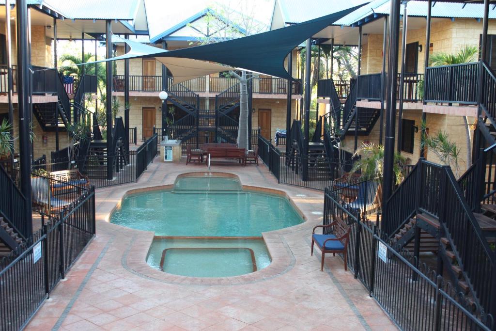 a large indoor pool with a large balcony at Apartments at Blue Seas Resort in Broome