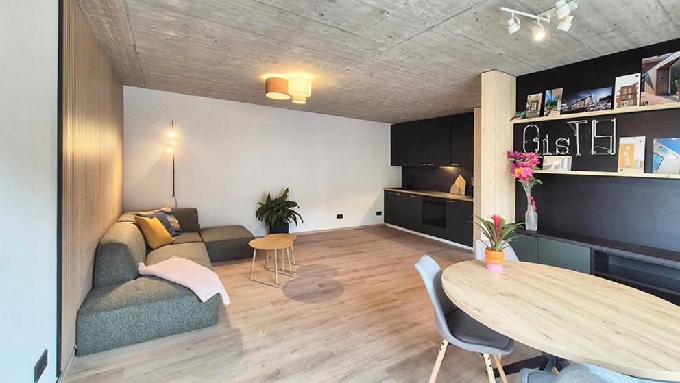 a living room with a couch and a table at Haus am FELS Steinbrech in Hermagor