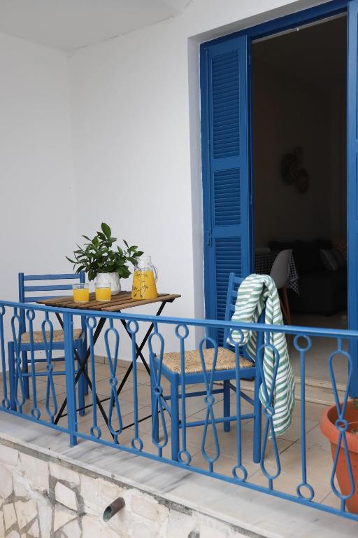 a blue table and chairs on a balcony at Traditional Town Garden Apartment in Rhodes Town